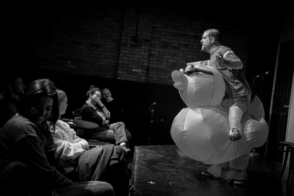 Bob on stage in inflatable duck costume at Sketchfest Chicago